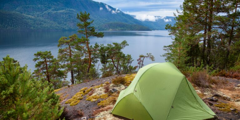 Image of a tent summer camping next to a lake