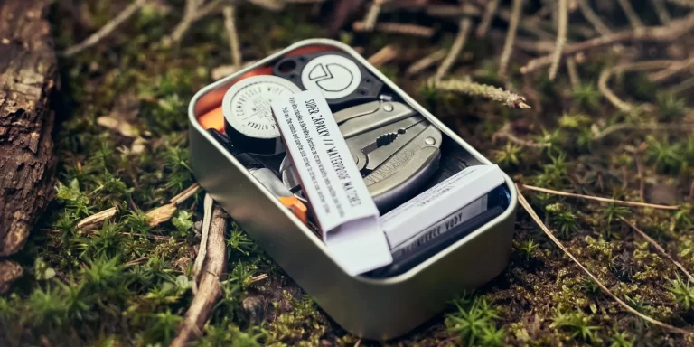 Pocket sized survival kit sitting on the ground