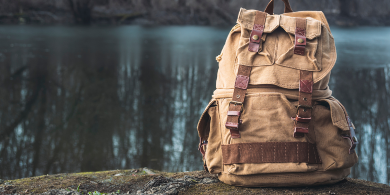 Survival bug-out-bag sitting next to a pond