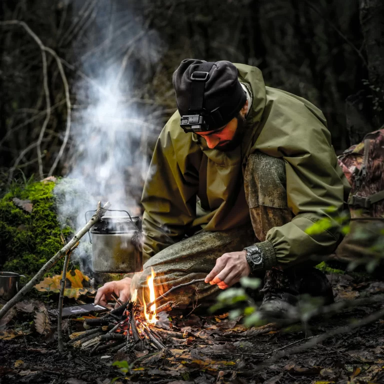 Emergency preparedness man in woods starting fire